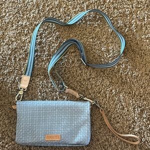 Consuela crossbody or clutch/wristlet when taking the strap off.